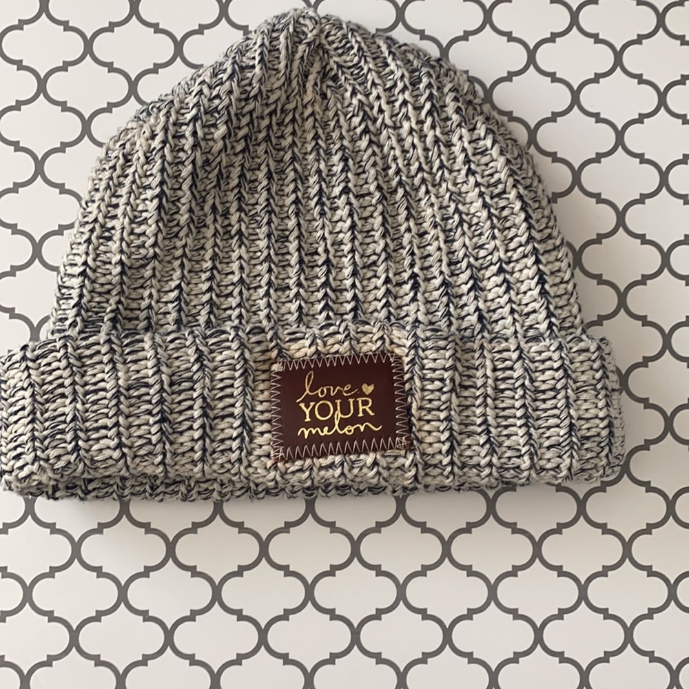 Love Your Melon hat! White and navy speckled with brown patch and gold foil.